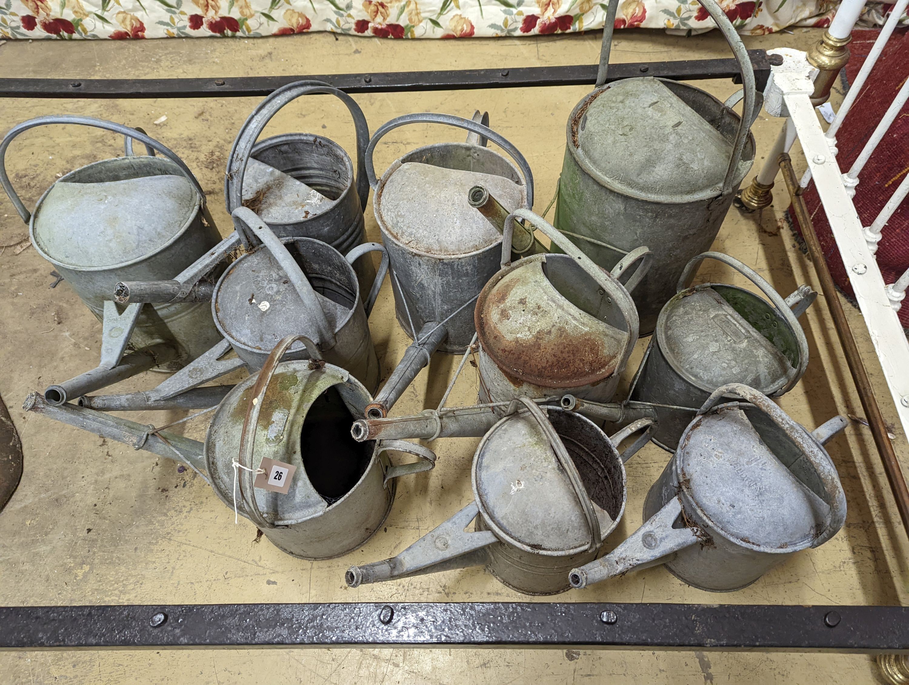 Ten vintage galvanised watering cans.